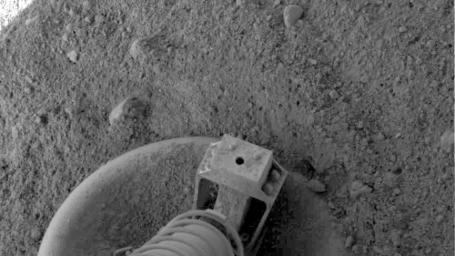NASA's Phoenix Mars Lander did a small amount of excavation as it touched down on pebbly north polar terrain on the Red Planet, as shown in this close-up view of one of the lander's three footpads.