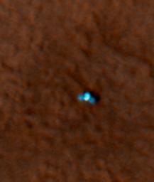 This is an enhanced-color image from Mars Reconnaissance Orbiter's High Resolution Imaging Science Experiment (HiRISE) camera. It shows the NASA's Mars Phoenix lander with its solar panels deployed on the Mars surface