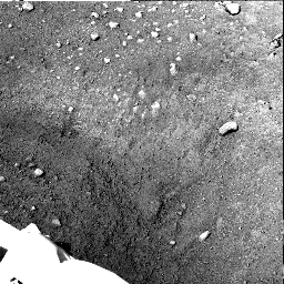 This from NASA's Phoenix Mars Lander's Stereo Surface Imager (SSI) camera shows Phoenix's parachute, backshell, heatshield, and impact site.