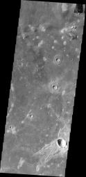 This image from NASA's Mars Odyssey shows craters on Mars with asymmetric ejecta blankets, typically formed by oblique impacts. The region of 'missing' ejecta indicates the direction of the incoming meteorite.