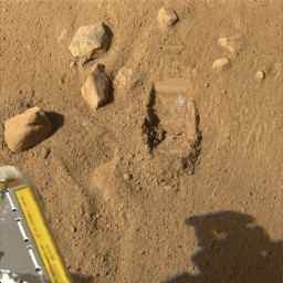 This image of the trench shows a white layer that has been uncovered by the Robotic Arm (RA) scoop onboard NASA's Phoenix Mars Lander and is visible in the wall of the trench.