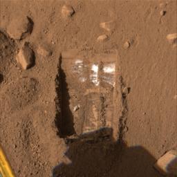 This image shows one trench informally called 'Dodo-Goldilocks' after two digs by NASA's Phoenix Mars Lander's robotic arm. White material, possibly ice, is located only at the upper portion of the trench.