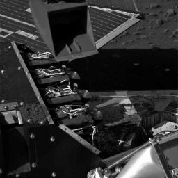 This image from NASA's Phoenix Mars Lander shows the lander's Robotic Arm scoop positioned over the Wet Chemistry Lab Cell 1 delivery funnel on July 6, 2008, after a martian soil sample was delivered to the instrument.
