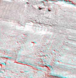 This view from NASA's Phoenix Mars Lander shows a portion of the trench informally named 'Snow White,' with two holes near the top of the image. 3D glasses are necessary to view this image.