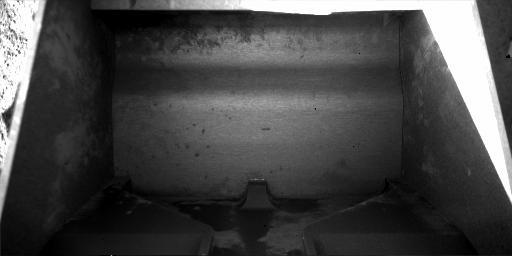 This view from July 25, 2008 by NASA's Phoenix Mars Lander shows the Robotic Arm scoop. The scoop was photographed to confirm it is empty in preparation for collecting a sample for analysis from a hard subsurface layer where soil may contain frozen water.