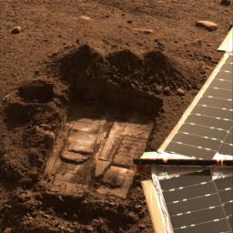 This image was acquired by NASA's Phoenix Mars Lander on July 8, 2008 showing the trench informally called 'Snow White.' Two samples were delivered to the Wet Chemistry Laboratory, part of the Microscopy, Electrochemistry, and Conductivity Analyzer.