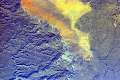 The impermanent waterways shown here from NASA's EarthKAM are part of Oued Irharrhar, which appear to be carrying sulfur (yellow) and iron (red) deposits. The city of Amguid is located on these waterways, and all lie in the Mouydir Mountains in Algeria.