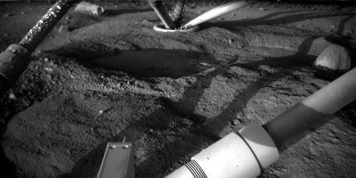 NASA's Phoenix Mars Lander took this image on Sept. 1, 2008. The view underneath the lander shows growth of the clumps adhering to leg strut.