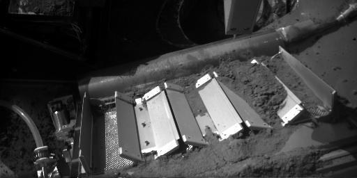 This image shows soil on the doors of the Thermal and Evolved Gas Analyzer (TEGA) onboard NASA's Phoenix Mars Lander. The image was taken by the lander on Oct. 7, 2008. This sample delivered to TEGA was named 'Rosy Red.'