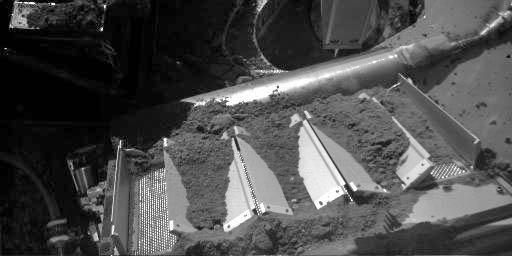 This image taken on Oct. 14, 2008 shows four of the eight cells in the Thermal and Evolved-Gas Analyzer, or TEGA, on NASA's Phoenix Mars Lander. TEGA's ovens, located underneath the cells, heat soil samples so the released gases can be analyzed.