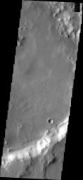 This image from NASA's Mars Odyssey shows dark slope streaks typically found in groups on Mars; however, this unnamed crater contains only a single dark slope streak. An old landslide is located just west of the streak.