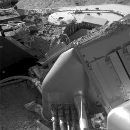 This image, taken by NASA's Phoenix Lander on Oct. 19, 2008, shows Martian soil piled on top of the spacecraft's deck. Visible in the upper-left portion of the image are several wet chemistry cells of the lander's MECA instrument.