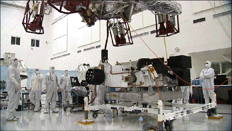 These three images show the progression of 'stacking' NASA's Mars Science Laboratory rover and its descent stage in one of NASA's Jet Propulsion Laboratory's 'clean room.' 