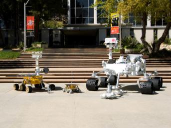 Full-scale models of three generations of NASA Mars rovers show the increase in size from the Sojourner rover of the Mars Pathfinder project, to the twin Mars Exploration Rovers Spirit and Opportunity, to the Mars Science Laboratory rover.