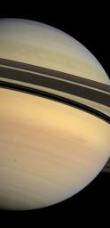 Saturn's rings cast a dramatic shadow separating the blues and greens of the planet's northern hemisphere from the creamy pastels coloring the southern hemisphere. This image was captured by NASA's Cassini spacecraft's wide-angle camera.
