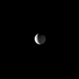 Sunlight illuminates a bright crescent on Saturn's moon Enceladus while Saturnshine dimly lights more of the moon. This view from NASA's Cassini spacecraft looks toward the Saturn-facing side of Enceladus (504 kilometers, or 313 miles across).