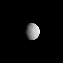 The huge Odysseus Crater disfigures the face of Saturn's moon Tethys in this image taken by NASA's Cassini spacecraft taken on Apr. 24, 2009.