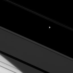 The moon Prometheus and a bit of Saturn's northern hemisphere are both brilliantly lit by the sun here, making the A ring seem dim in comparison. This image from NASA's Cassini spacecraft.