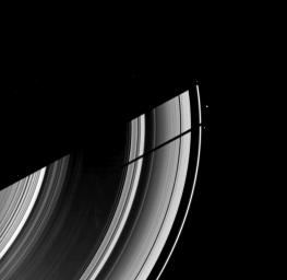 The moon Tethys casts its shadow on Saturn's rings next to the shadow of the planet in this image taken as Saturn approaches its August 2009 equinox. This image is from as seen by NASA's Cassini spacecraft.