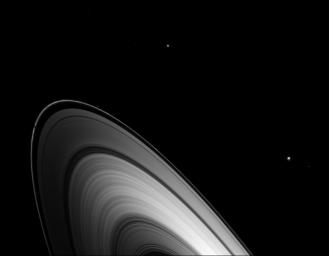 Just before Saturn's August 2009 equinox, Dione joined other Saturnian moons in casting shadows on the planet's main rings as seen by NASA's Cassini spacecraft.