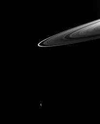 Beyond the ansa of Saturn's rings, a crescent Rhea completes this ring-and-moon composition captured by NASA's Cassini spacecraft.
