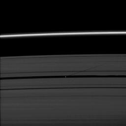 The moon Pan casts a shadow on Saturn's outer A ring in this image taken as the planet approached its August 2009 equinox. NASA's Cassini spacecraft took this image on July 29, 2009.