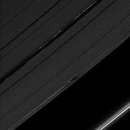 The shadows cast by Daphnis' attendant edge waves create a dark, jagged pattern on the A ring in this image taken by NASA's Cassini spacecraft on July 28, 2009 as Saturn approached its August 2009 equinox.