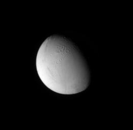 NASA's Cassini spacecraft looks down at craters near the north pole of Saturn's moon Enceladus. Cratered surfaces on solar system moons indicate older terrains, while smooth surfaces are generally younger.
