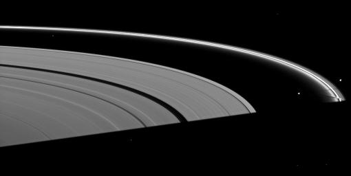 Saturn's moon Prometheus casts a shadow near a streamer-channel created by the moon in the thin F ring in this image taken by NASA's Cassini spacecraft about a month after the planet's August 2009 equinox.