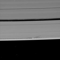 Long shadows stretch away from the towering edge waves created by the gravity of the moon Daphnis in this image taken by NASA's Cassini spacecraft a little more than a week before Saturn's August 2009 equinox.