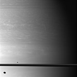 This image, taken by NASA's Cassini spacecraft, shows the shadows of two moons as they appear on Saturn, above and below the plane of the planet's rings.