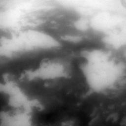 The low albedo feature known as Senkyo is visible through the haze of Titan's atmosphere in this image captured by NASA's Cassini spacecraft.