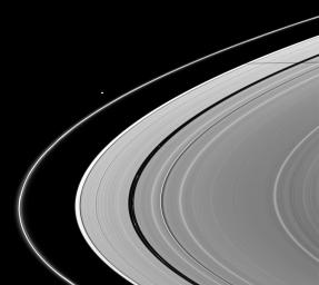A pair of Saturn's moons, Pan and Janus, cast their shadows on the A ring in this NASA's Cassini spacecraft image taken about a month and a half after Saturn's August 2009 equinox.