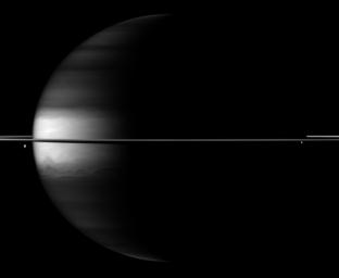 Dramatic differences between dark and light embellish image of Saturn, its rings and its moons Dione and Enceladus in this image taken by NASA's Cassini spacecraft.