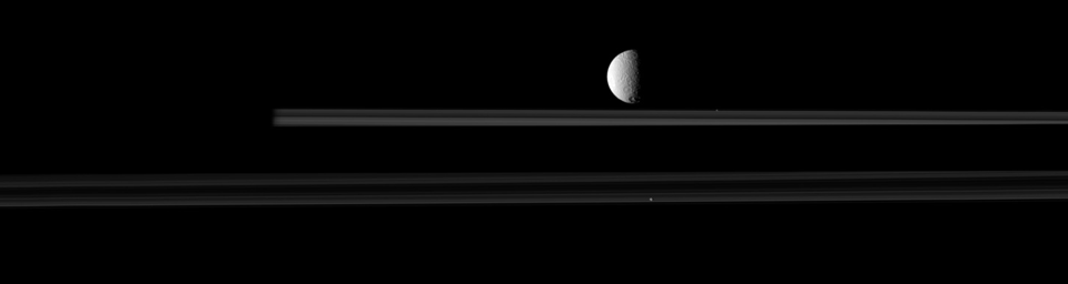 The moon Tethys is upstaged by two smaller moons, Pandora and Prometheus, in this image from NASA's Cassini spacecraft. Go to the Photojournal to view the animation.