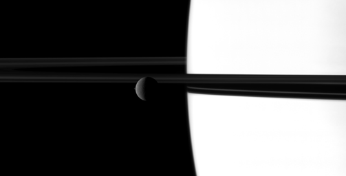 The small moon Janus overtakes the larger moon Rhea in a dance played out before Saturn and its rings in this image taken by NASA's Cassini spacecraft. Go to the Photojournal to view the animation.