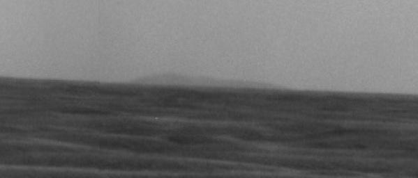 A high point on the distant eastern rim of Endeavour Crater is visible on the horizon of this image taken by NASA's Mars Exploration Rover Opportunity on March 8, 2009.