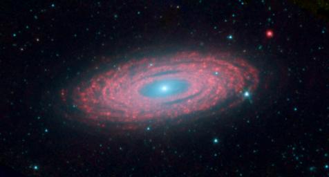 This image from NASA's Spitzer Space Telescope shows the spiral galaxy NGC 2841, located about 46 million light-years from Earth in the constellation Ursa Major. The galaxy is helping astronomers solve one of the oldest puzzles in astronomy.