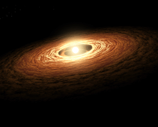 This artist's concept illustrates how silicate crystals like those found in comets can be created by an outburst from a growing star. The image shows a young sun-like star encircled by its planet-forming disk of gas and dust. Animation available.