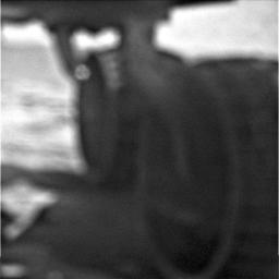On May 18, 2009, NASA's Mars Exploration Rover Opportunity used its microscopic imager camera to take a picture of its underside. Though out-of-focus, shown are the rover wheels and underside of the rover.
