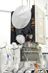 Workers secure the attachments of NASA's Dawn spacecraft onto the upper stage booster.