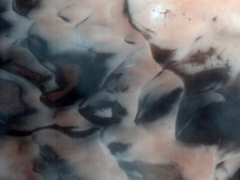 This image from NASA's Mars Reconnaissance Rover shows the north polar region of Mars is surrounded by a large sea of dark sand dunes that become covered by seasonal carbon dioxide frost.