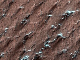 NASA's Mars Reconnaissance Rover spied these spider-like formations, likely caused as carbon dioxide ice changes from a solid to a gas; the gas moves through channels until it reaches the surface and vents out. 
