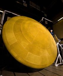 This image shows NASA's Mars Science Laboratory heat shield, and a spacecraft worker at Lockheed Martin Space Systems, Denver. It is the largest heat shield ever built for descending through the atmosphere of any planet.