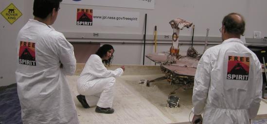 Mars Exploration Rover team members on July 21, 2009, tested how altering the order in which individual wheels turn for steering affects how those turns dig the wheels deeper into soft soil. From left: Alfonso Herrera, Vandana Verma, Bruce Banerdt.
