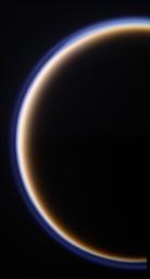 Titan's golden, smog-like atmosphere and complex layered hazes appear to NASA's Cassini Oribter as a luminous ring around the planet-sized moon.