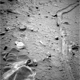 This view from the navigation camera near the top of the mast on NASA's Mars Exploration Rover Spirit shows the tracks left by the rover as it drove southward and backward, dragging its inoperable right-front wheel.