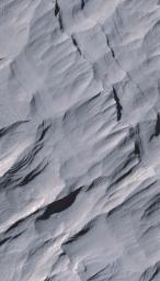Layers of rock in the upper portion of a tall mound near the center of Gale Crater on Mars exhibit a regular thickness of several meters in this image taken by NASA's Mars Reconnaissance Orbiter.