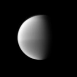 Titan's seasonal hemispheric dichotomy is chronicled in black and white, with the moon's northern half appearing slightly lighter than the dark southern half in this image taken by NASA's Cassini spacecraft.