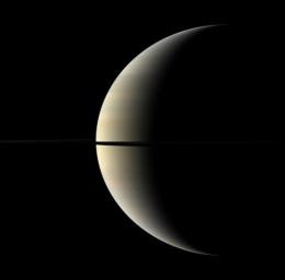 A pastel crescent of Saturn is interrupted by the moon Mimas and the rings in this color image captured by NASA's Cassini spacecraft. Mimas (396 kilometers, or 246 miles across) appears as a dark speck just above the rings.